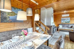a living room with a table and a couch at Seepark-Lodge in Kirchheim +22 photos