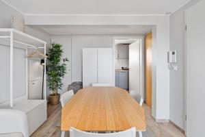a dining room with a wooden table and chairs at Modern Limpertsberg Studio Near City Center in Luxembourg