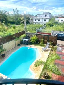 a large blue swimming pool in a yard at Appartement first floor in Trou aux Biches