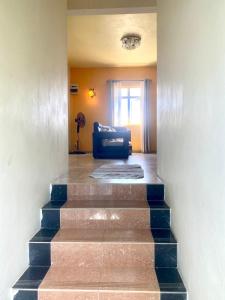 a stairway with a blue couch in a living room at Appartement first floor in Trou aux Biches +12 photos