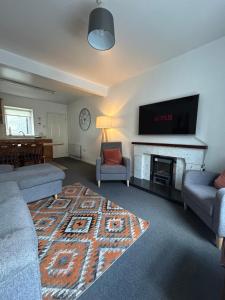 a living room with two couches and a fireplace at Central Town House,Moville 61 in Moville