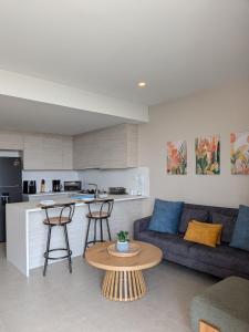 a living room with a couch and a table at Apartamento en Manzanillo con salida directa a la playa in Cartagena de Indias