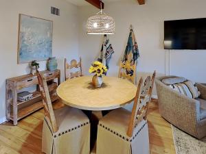 a dining room with a wooden table and chairs at Casa Cielo in Santa Fe