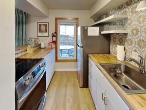 a kitchen with a stainless steel refrigerator and a sink at Casa Cielo in Santa Fe +17 photos