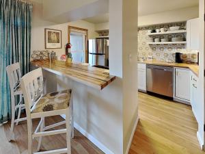 a kitchen with a counter and chairs in a room at Casa Cielo in Santa Fe