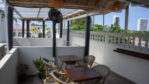 a balcony with two tables and chairs and windows at Art Hotel Getsemani in Cartagena de Indias