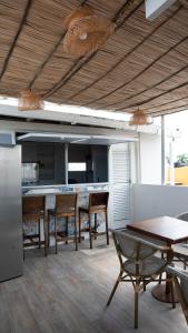a kitchen with a table and some chairs and a table and a tableasteryastery at Art Hotel Getsemani in Cartagena de Indias