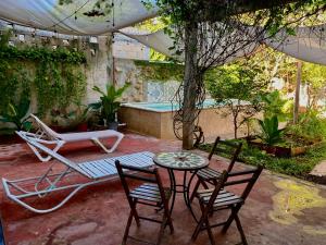 a patio with a table and chairs and a pool at Departamento Luna in Valladolid