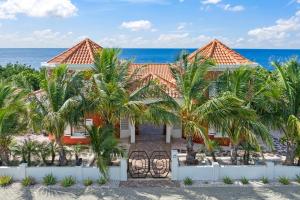 a house on the beach with palm trees at Sunset House in Willibrordus