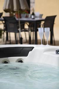 two wine glasses sitting in a swimming pool at Au logis de Bayard in Vareilles