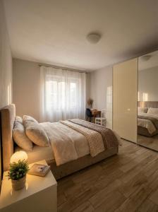 a bedroom with a bed and a large window at Oasi Domese Appartamento Centrale in Domodossola