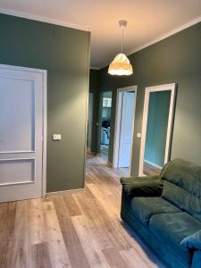 a living room with a couch and a hallway at Ca Sunder in Sondrio +3 photos
