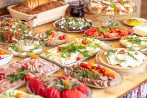 a table topped with lots of different types of food at Gościniec Rabe - Agro&SPA in Ustrzyki Dolne