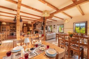 an open living room with wooden ceilings and a dining room at Gościniec Rabe - Agro&SPA in Ustrzyki Dolne