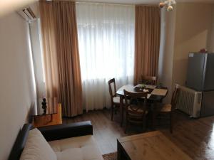 a living room with a couch and a dining room table at Апартамент Light blue in Troyan +22 photos