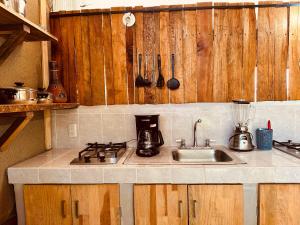 a kitchen with a sink and a counter top at Suites Costa Madéro - Punta Zicatela in Brisas de Zicatela