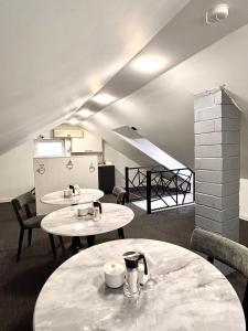 a room with two tables and chairs and a staircase at JM Central Boutique Hotel in Baku
