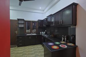 a kitchen with black cabinets and a black counter top at Canal's Edge in Negombo