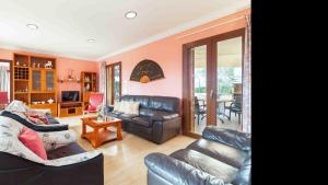 a living room with two leather couches and a table at Son Monget in Muro