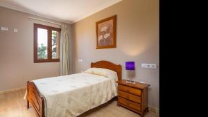 a bedroom with a bed and a dresser and a window at Son Monget in Muro +22 photos