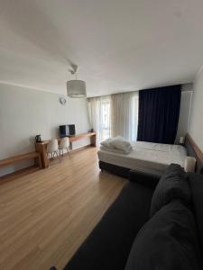 a bedroom with a bed and a desk and a tv at Оrbi Palase Deluxe in Bakuriani