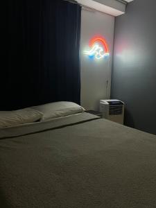 a bedroom with a bed and a neon sign at Estudio in Zamora de Hidalgo