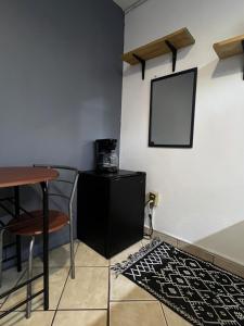 a room with a table and chairs and a mirror at Estudio in Zamora de Hidalgo