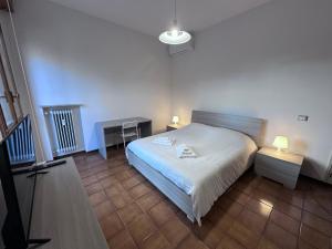 a bedroom with a bed and a table and a lamp at Hospital - WI-FI 3 Bedrs in Reggio Emilia +14 photos