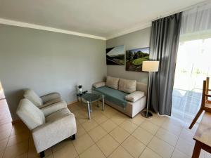 a living room with a couch and a chair at Gościniec Wigry 1 in Walne