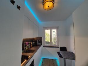 a kitchen with a blue light on the ceiling at FeWo Altstadt in Stralsund