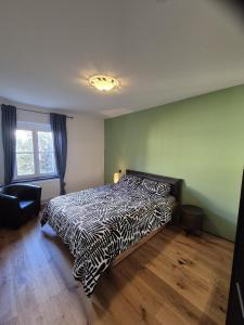 a bedroom with a bed with a black and white comforter at FeWo Altstadt in Stralsund
