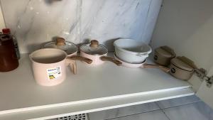 a group of pots and pans sitting on a counter at Via do Sol flats in Amontada +10 photos