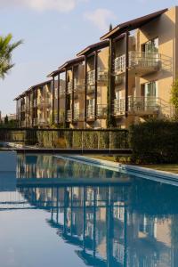 a building with a pool in front of it at Concorde Luxury Resort & Casino in Vokolidha