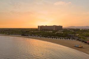 a view of a beach with a hotel in the background at Concorde Luxury Resort & Casino in Vokolidha