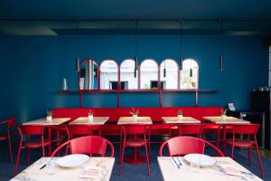 a dining room with red tables and red chairs at Esqina Cosmopolitan Lodge in Lisbon +81 photos