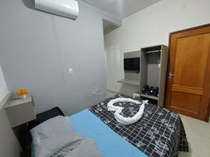 a room with a bed with two tubes on it at Suíte Casal - Queen's Hotel in Formosa +19 photos