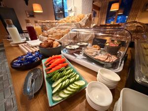 a buffet with vegetables and other foods on a table at Boutique Hotel Alpenhof in Sankt Martin am Tennengebirge