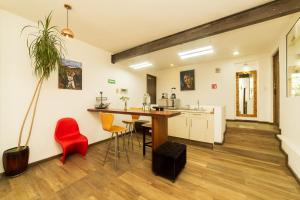 a kitchen with a table and chairs in a room at Hotel Casa Anzures in Mexico City