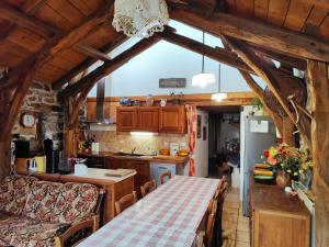a kitchen with a table and a counter top at La Butinerie in Prévenchères