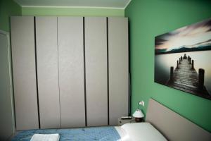 a bedroom with a bed with a picture on the wall at Casa Fulvia in Rozzano +7 photos