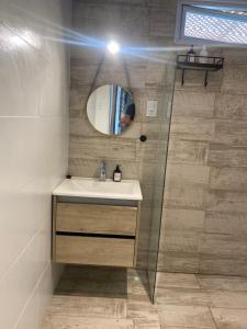 a bathroom with a sink and a mirror at Estudio Villa Rosas in Rafaela +7 photos