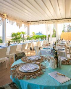 a table with a blue table cloth and some chairs at Hotel Bellariva in Lido di Jesolo