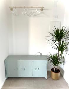 a blue cabinet in a room with two plants at Pantone - Sarnico Color Suites in Sarnico +15 photos