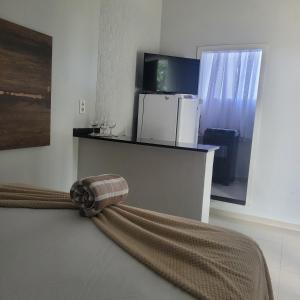 a room with a bed and a refrigerator at Apartamento in União da Vitória +8 photos
