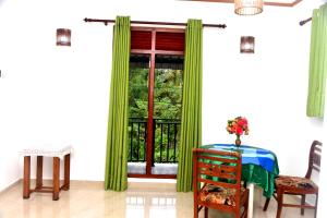 a room with a window with green curtains at AERO View Villa in Induruwa