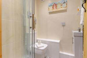 a bathroom with a toilet and a glass shower at 4 Bed in Sheringham oc-m28357 in Sheringham +25 photos