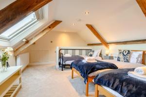 two beds in a attic bedroom with a window at 4 Bed in Sheringham oc-m28357 in Sheringham