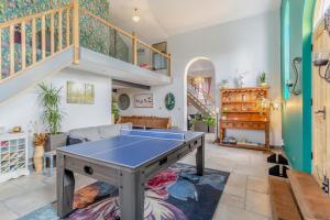 a ping pong table in a room with a staircase at 3 Bed in Crowle oc-s30617 in Crowle