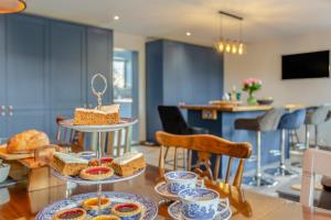 a table with three tiers of cakes and pastries at 3 Bed in Crowle oc-s30617 in Crowle