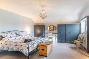 a bedroom with a bed and a chair and a table at 3 Bed in Crowle oc-s30617 in Crowle